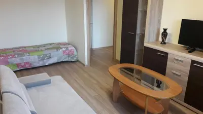 a small living room with a television and a table at Tulpių apartamentai in Panevėžys