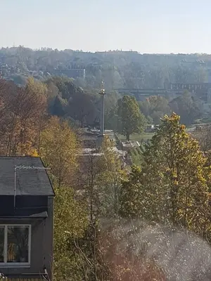 a view of a field with a cross in the distance at Apartamentai Centras in Šiauliai