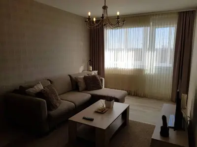 a living room with a couch and a coffee table at Apartamentai Centras in Šiauliai