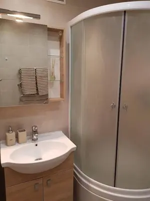 a bathroom with a sink and a shower at Apartamentai Centras in Šiauliai