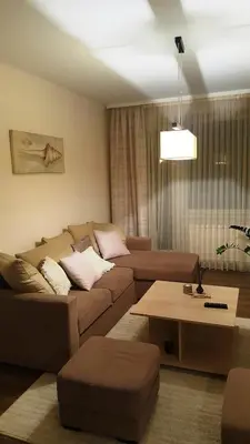 a living room with a couch and a coffee table at Apartamentai Dainų in Šiauliai