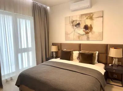 a bedroom with a bed and a large window at Apartamentai Vytauto Street in Šiauliai