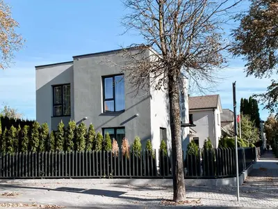 a house with a fence in front of it at Apartamentai Vytauto Street in Šiauliai