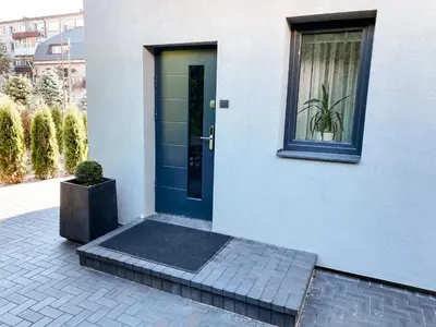 a blue door of a house with a potted plant at Apartamentai Vytauto Street in Šiauliai