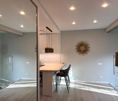 a kitchen and dining room with a table and chairs at Apartamentai Vytauto Street in Šiauliai