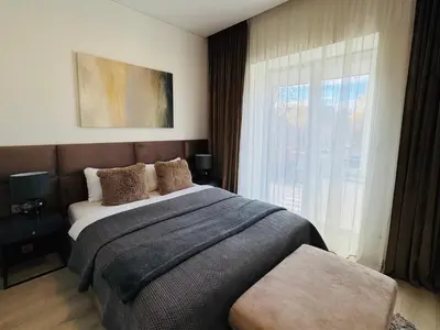 a bedroom with a large bed and a window at Apartamentai Vytauto Street in Šiauliai