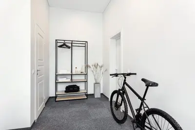 a bike parked in a room with a white wall at Kaunas Garden in Kaunas