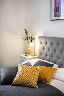 a bedroom with a bed with pillows on it at Kaunas Garden in Kaunas