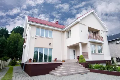 a white house with a red roof at VGH accommodation services in Vilnius