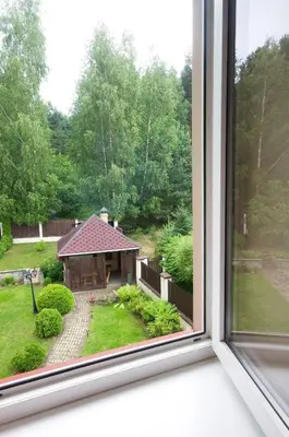 an open window with a view of a backyard at VGH accommodation services in Vilnius