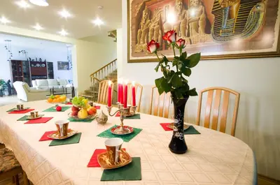 a table with candles and plates of food on it at VGH accommodation services in Vilnius