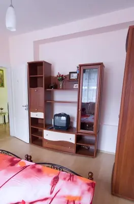 a bedroom with a dresser and a mirror at VGH accommodation services in Vilnius