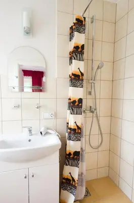 a bathroom with a sink and a shower curtain at VGH accommodation services in Vilnius
