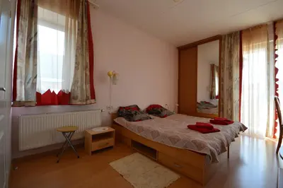 a bedroom with a bed with red towels on it at VGH accommodation services in Vilnius