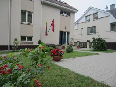 a building with two flags on the side of it at VGH accommodation services in Vilnius