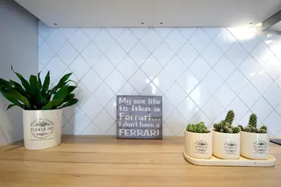 three potted plants sitting on a counter with a sign at Cosy 1BD Apartment in Old Town by Domvia in Kaunas
