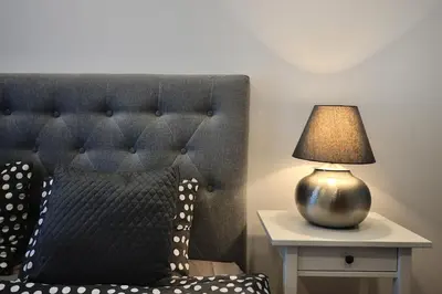 a lamp sitting on a table next to a bed at Cosy 1BD Apartment in Old Town by Domvia in Kaunas