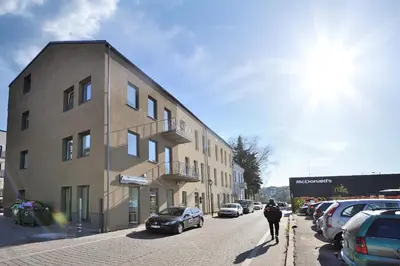 a man walking down a street next to a building at Cosy 1BD Apartment in Old Town by Domvia in Kaunas