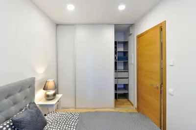 a bedroom with a bed and a wooden door at Cosy 1BD Apartment in Old Town by Domvia in Kaunas