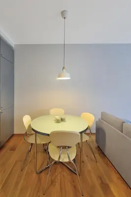 a dining room table with chairs and a couch at Cosy 1BD Apartment in Old Town by Domvia in Kaunas