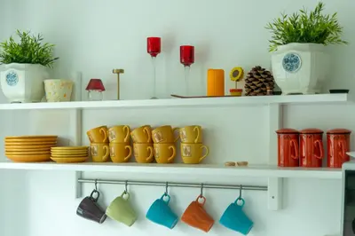 a shelf with a bunch of bowls and plates at Du draugai 1 in Druskininkai