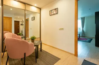 a room with chairs and a table and a mirror at Du draugai 1 in Druskininkai