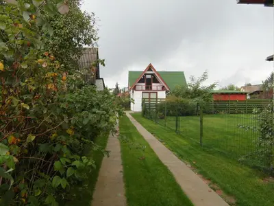 a path in front of a house with a fence at White Cottage in Druskininkai