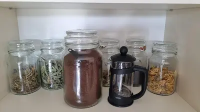 a shelf with jars of food and a coffee pot at Garden Studio by the Lake with Air-Con and Infrasauna in Druskininkai