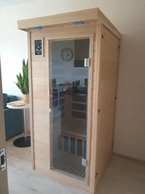 a room with a glass door in a room at Garden Studio by the Lake with Air-Con and Infrasauna in Druskininkai