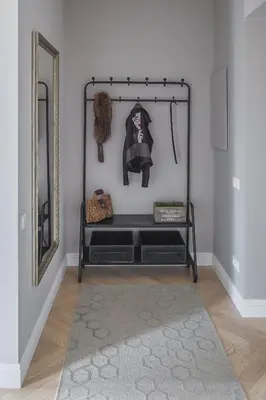 a black shelf in a room with a mirror at Avenue in Šiauliai