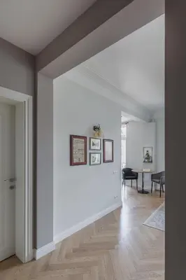 a living room with white walls and wood floors at Avenue in Šiauliai
