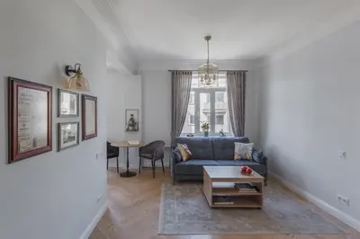 a living room with a blue couch and a table at Avenue in Šiauliai