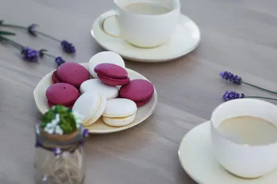 a table with plates of cookies and a cup of coffee at Avenue in Šiauliai