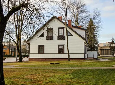 a large white house with a gambrel at Centro apartamentai in Birštonas