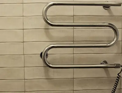 two metal towel racks on a tiled wall at Centro apartamentai in Birštonas