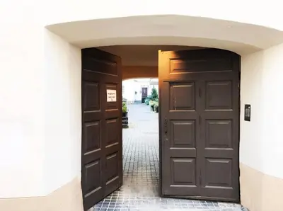 an entrance to a building with two brown doors at Luxury old town apartment in Vilnius