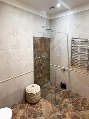 a bathroom with a shower with a glass door at Luxury old town apartment in Vilnius