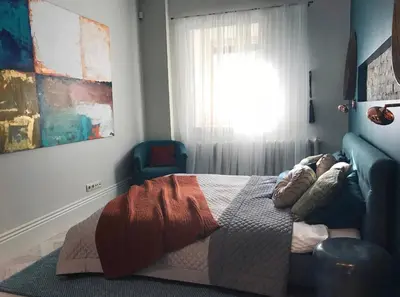 a bedroom with a bed and a window at Luxury old town apartment in Vilnius