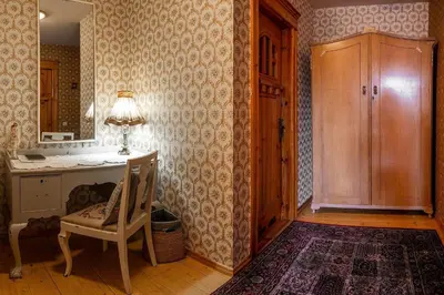 a room with a desk and a chair and a lamp at Pakruojis Manor Hotel Miller's house in Pakruojis