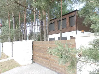 a wooden fence in front of a house at forest-house lt in Druskininkai
