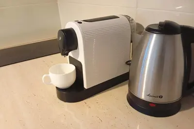 a toaster and a coffee maker on a counter at forest-house lt in Druskininkai