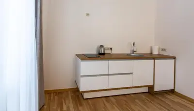 a kitchen with a sink and a counter at Violetos Lux Apartamentai2 in Druskininkai