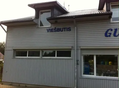 a building with a west builds sign on it at Guest House Guba in Molėtai