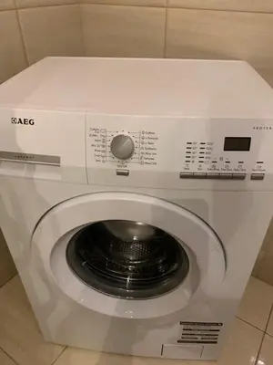 a white washing machine in a room at Near Station Apartment in Vilnius