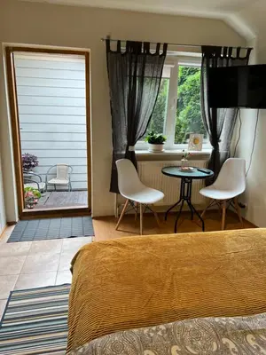 a bedroom with a bed and a table and chairs at Center studio hause in Kaunas