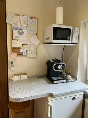 a kitchen with a counter top with a microwave and a counter sidx sidx at Center studio hause in Kaunas