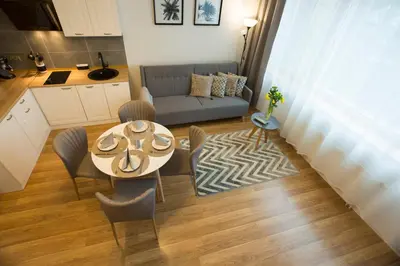 a living room with a table and a couch at Relax Birstonas in Birštonas