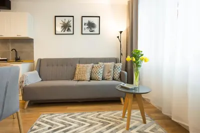 a living room with a couch and a table at Relax Birstonas in Birštonas