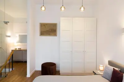 a bedroom with a white closet and a bed at Relax Birstonas in Birštonas