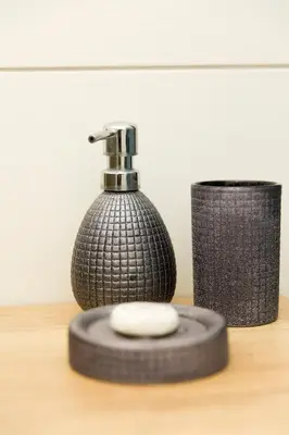 a black soap dispenser sitting on a table next to a tire at Relax Birstonas in Birštonas